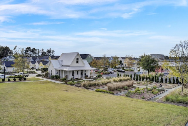 view of property's community with a yard, a vegetable garden, and a residential view