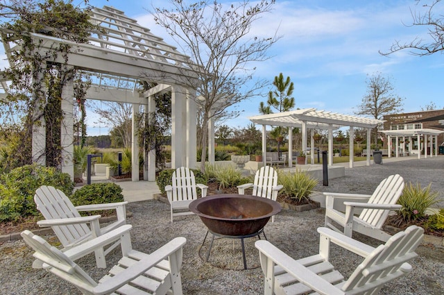 view of patio with a fire pit and a pergola