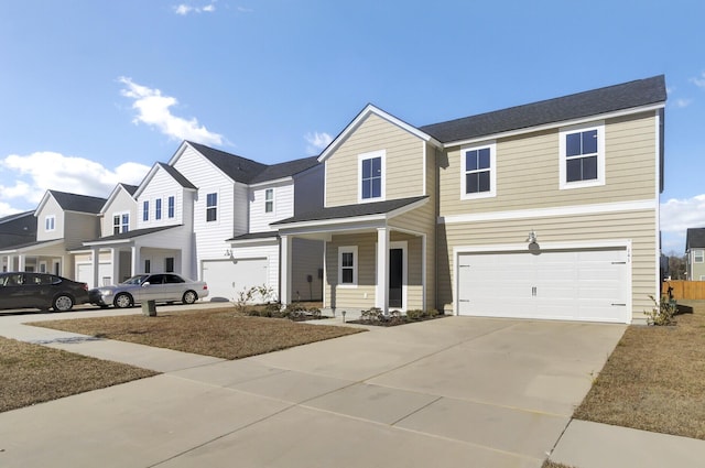 view of front of house with driveway, a garage, and a residential view