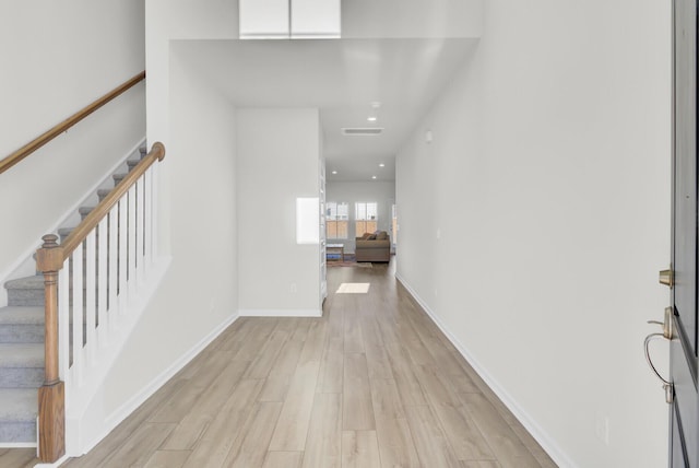 entrance foyer featuring light wood finished floors, recessed lighting, visible vents, baseboards, and stairs