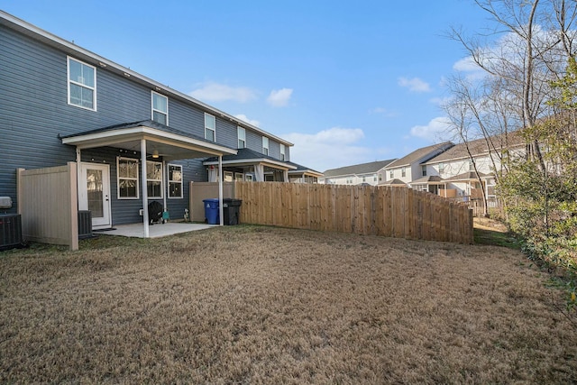 rear view of house with a yard and a patio area