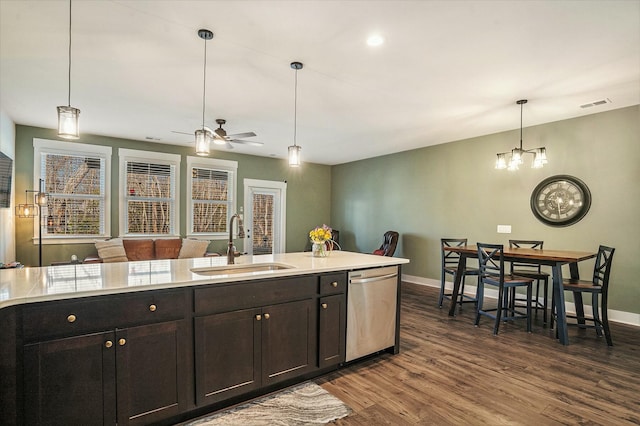 kitchen with ceiling fan with notable chandelier, dishwasher, sink, dark hardwood / wood-style flooring, and hanging light fixtures