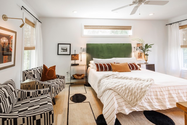 bedroom with ceiling fan and light wood-type flooring