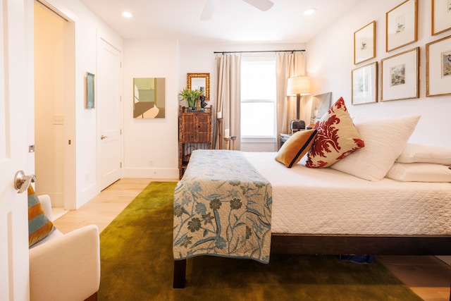 bedroom with light hardwood / wood-style flooring and ceiling fan