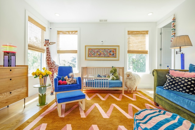 sitting room with hardwood / wood-style flooring and a wealth of natural light