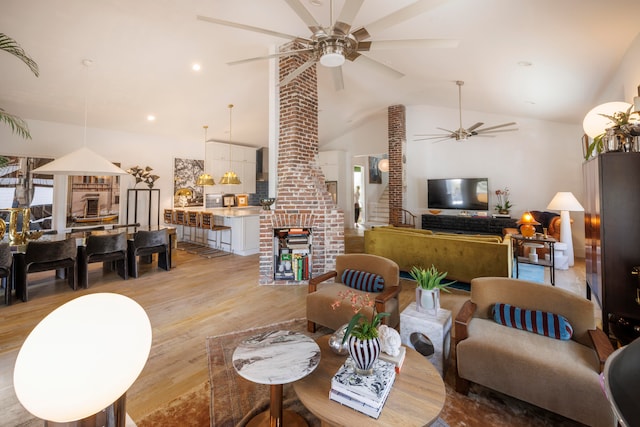 living room featuring lofted ceiling and light hardwood / wood-style flooring