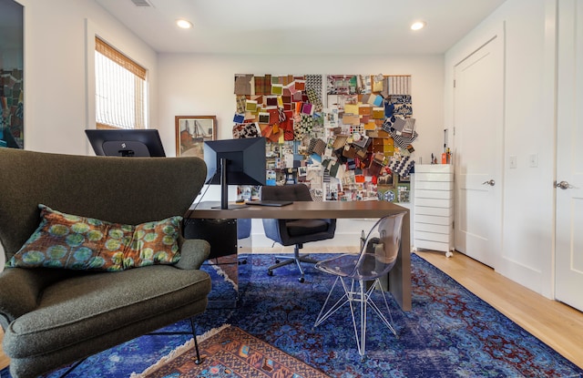 home office with hardwood / wood-style floors