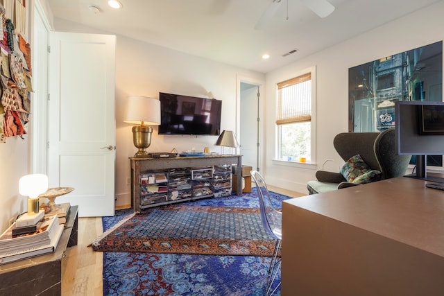 living room with hardwood / wood-style floors and ceiling fan