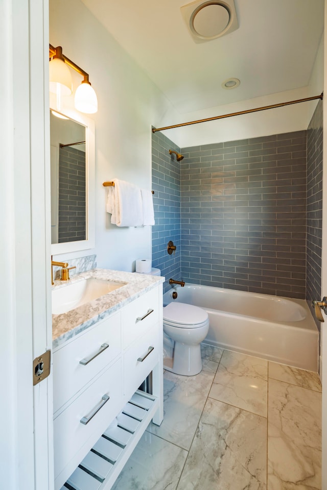 full bathroom featuring vanity, toilet, and tiled shower / bath combo