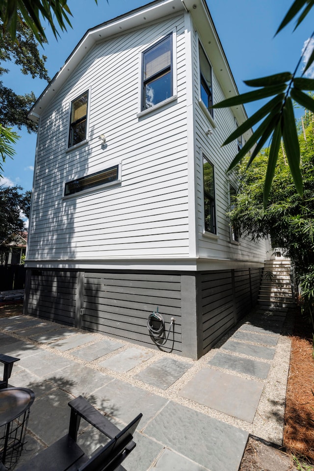 view of side of property with a patio