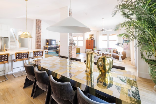 dining room with light hardwood / wood-style flooring, ceiling fan, and lofted ceiling