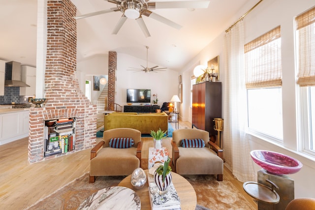 living room with light hardwood / wood-style flooring and lofted ceiling