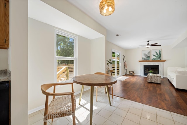 8112 Halifax Way N, Charleston, SC 29420 - dining room with a glass covered fireplace, a ceiling fan, and light tile patterned floors