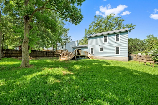 8112 Halifax Way N, Charleston, SC 29420 - rear view of house featuring a fenced backyard, stairway, and a wooden deck