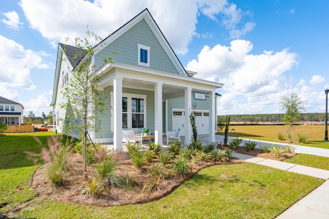 view of front facade with a front yard, a porch, and a garage