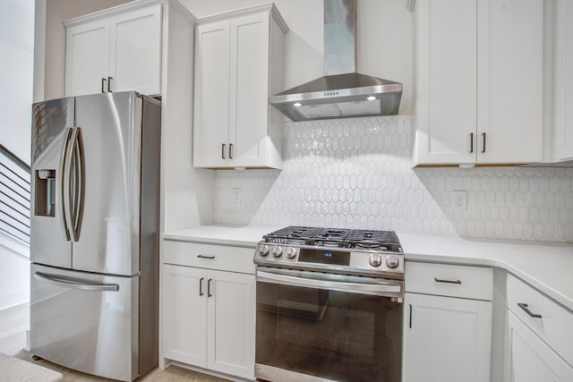 4067 S Rhett Ave, North Charleston, SC 29405 - kitchen with appliances with stainless steel finishes, wall chimney range hood, light countertops, and white cabinets