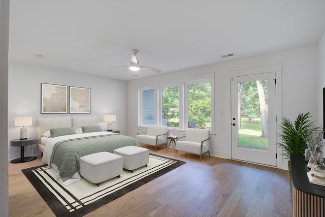 4067 S Rhett Ave, North Charleston, SC 29405 - bedroom featuring access to outside, multiple windows, and wood finished floors