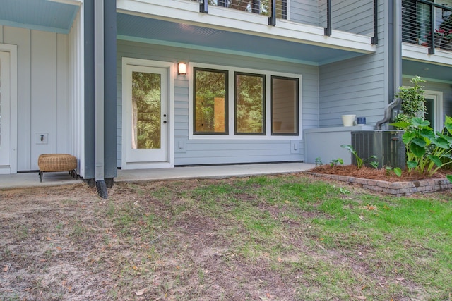 4067 S Rhett Ave, North Charleston, SC 29405 - property entrance featuring central AC unit, a balcony, and board and batten siding