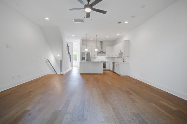 4067 S Rhett Ave, North Charleston, SC 29405 - unfurnished living room with a sink, a ceiling fan, light wood-style floors, baseboards, and recessed lighting