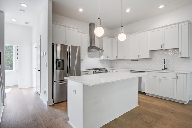 4067 S Rhett Ave, North Charleston, SC 29405 - kitchen with stainless steel appliances, wall chimney range hood, a sink, a center island, and backsplash