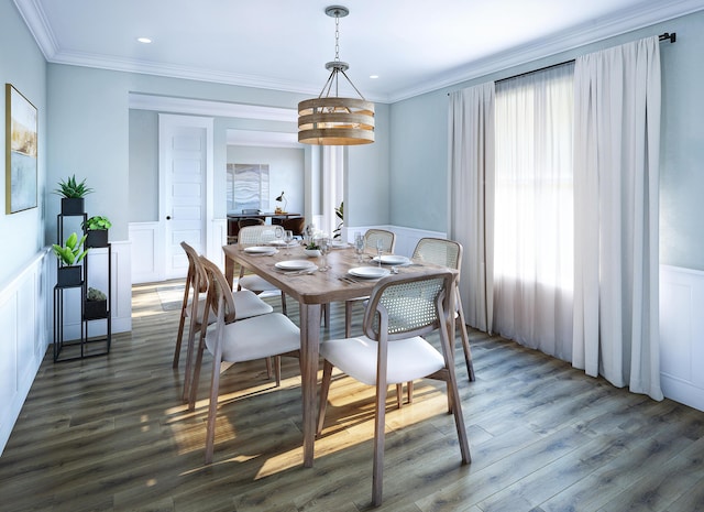 dining room featuring a wainscoted wall, wood finished floors, crown molding, and a decorative wall