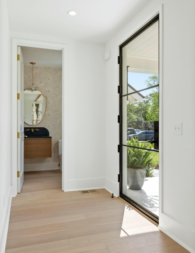 entrance foyer with light wood-style floors, baseboards, and recessed lighting