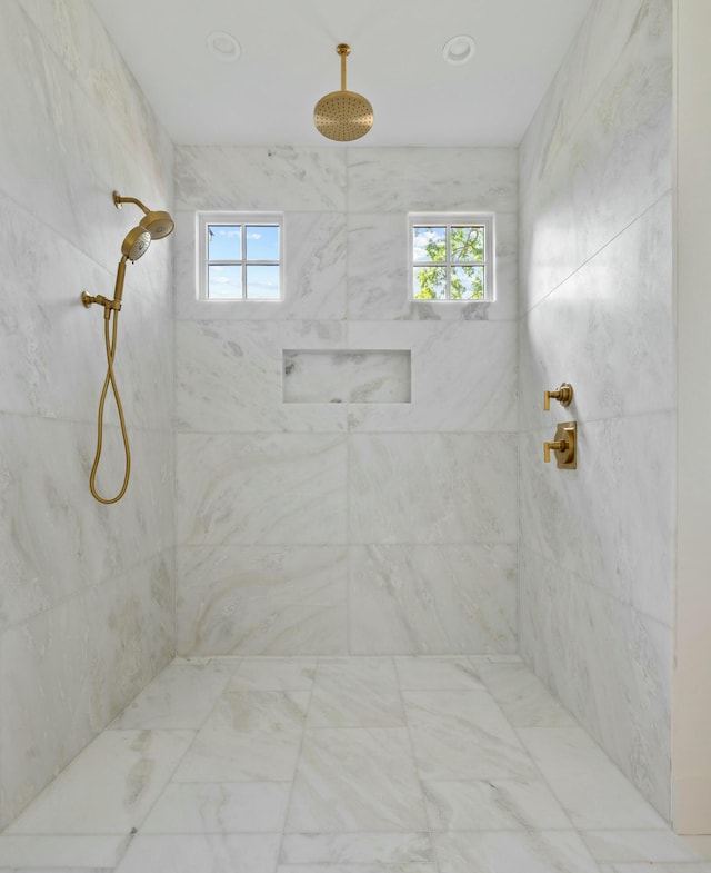 full bathroom with healthy amount of natural light and tiled shower