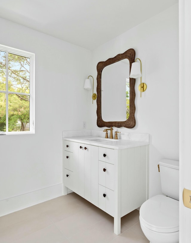 bathroom with toilet, tile patterned flooring, and vanity