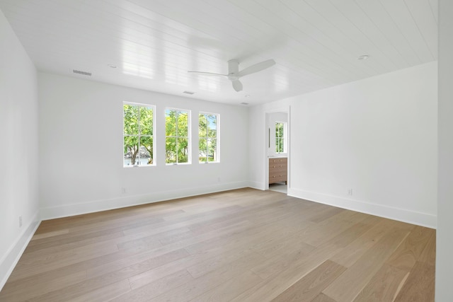 spare room with ceiling fan, baseboards, and light wood-style floors