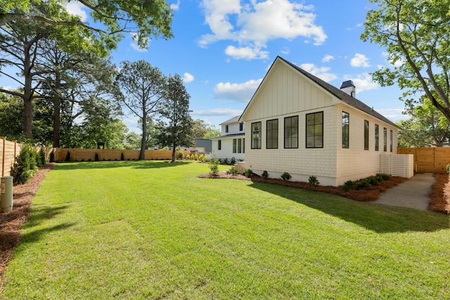 view of side of property featuring a chimney and board and batten siding