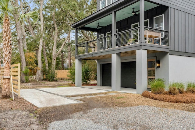 view of property exterior with ceiling fan, a balcony, and a garage