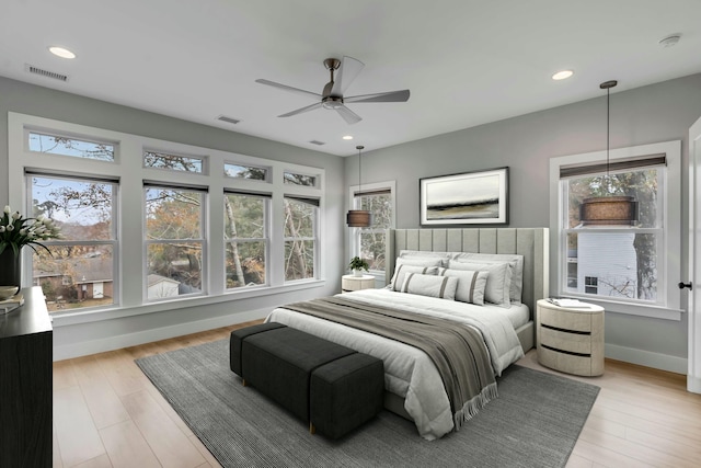 bedroom with ceiling fan and light wood-type flooring