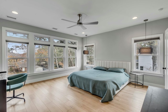 bedroom with hardwood / wood-style floors and ceiling fan