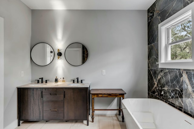 bathroom featuring vanity and a tub to relax in