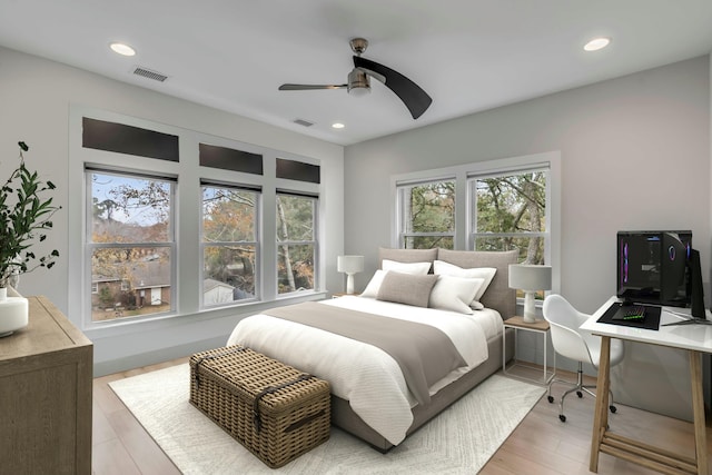 bedroom with light hardwood / wood-style flooring and ceiling fan