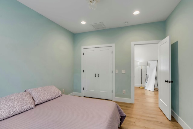 bedroom featuring a closet and light wood-type flooring