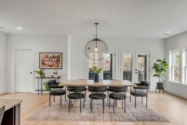 dining room featuring french doors and light wood-type flooring