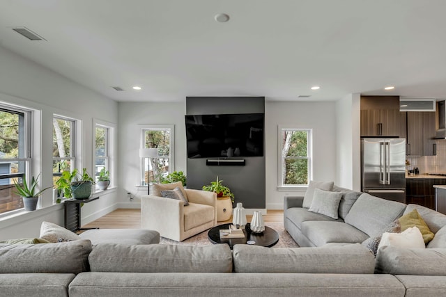 living room with light hardwood / wood-style flooring