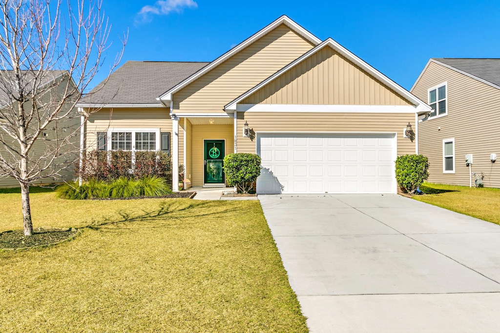 view of front of house featuring a garage and a front lawn