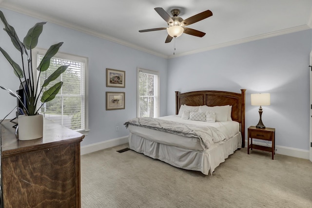 carpeted bedroom featuring ceiling fan and ornamental molding