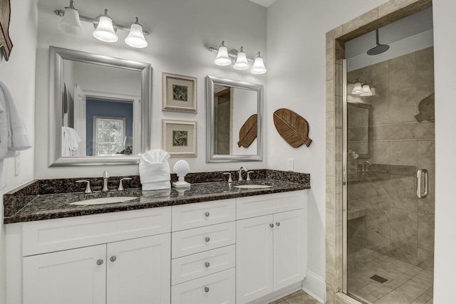 bathroom featuring tile patterned flooring, vanity, and walk in shower