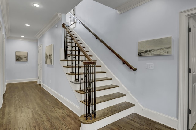 stairs with hardwood / wood-style flooring and ornamental molding