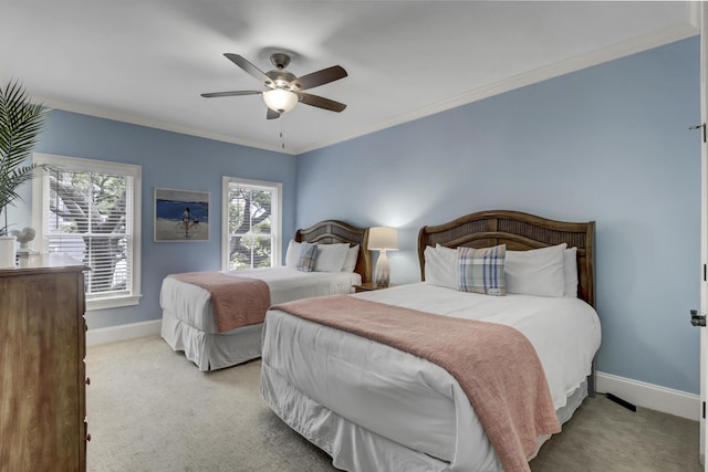 carpeted bedroom with ceiling fan and crown molding