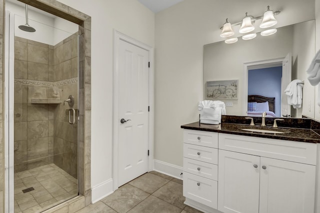 bathroom with vanity, tile patterned floors, and a shower with door