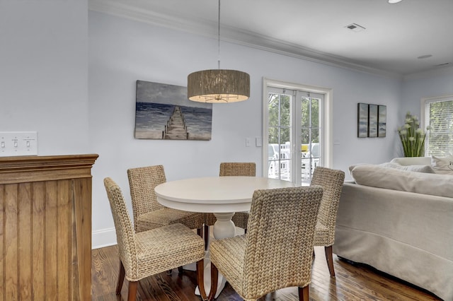 dining space with hardwood / wood-style floors, french doors, and ornamental molding