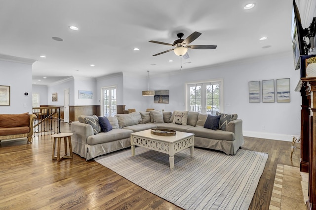 living room featuring ceiling fan, hardwood / wood-style floors, and ornamental molding