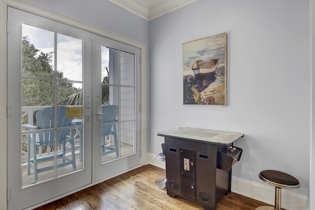 entryway featuring crown molding, french doors, and hardwood / wood-style floors