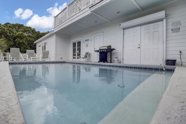 view of pool featuring a grill