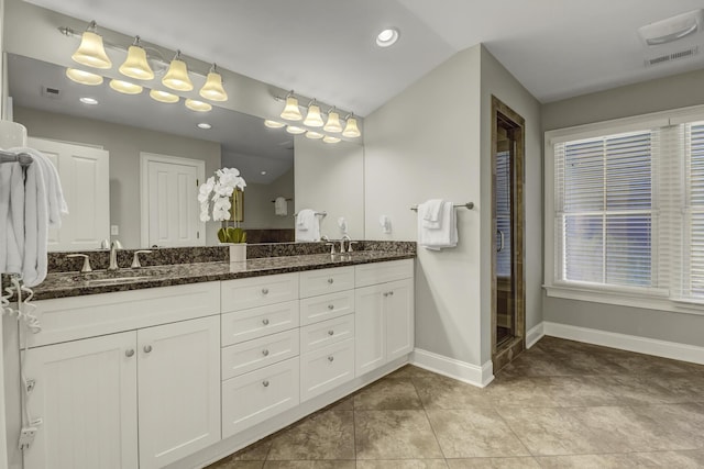 bathroom featuring vanity, tile patterned floors, a shower with shower door, and lofted ceiling