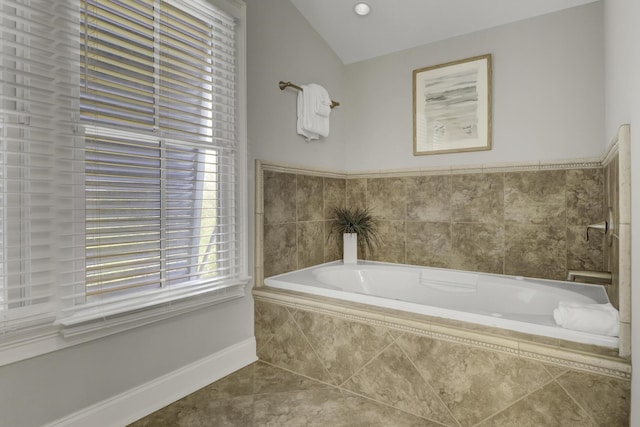 bathroom featuring tile patterned flooring and tiled tub